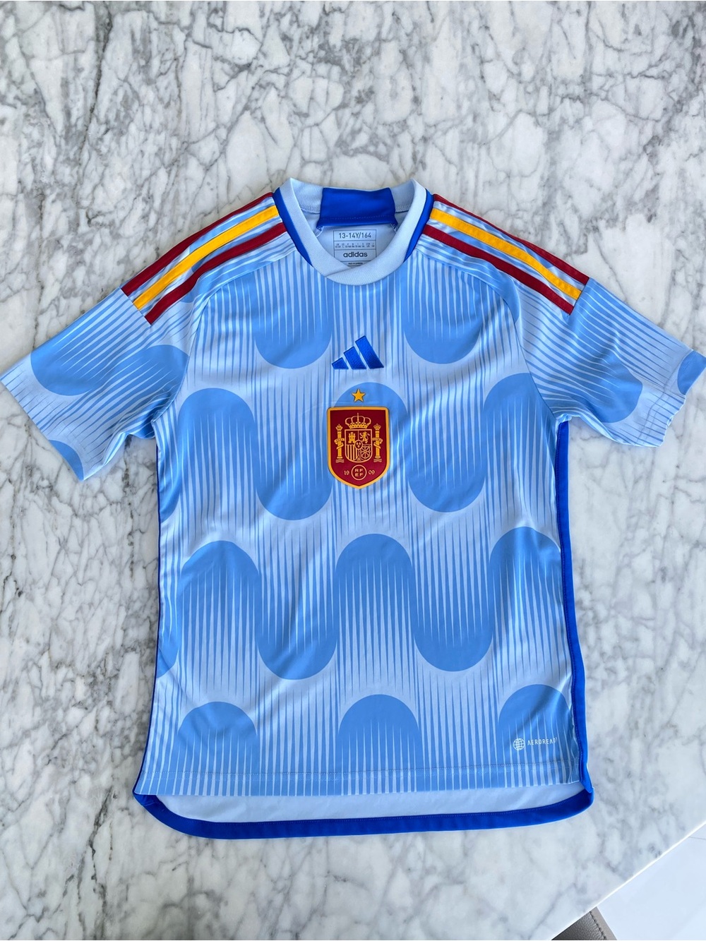 adidas Light Blue Spain Wave Soccer Jersey with Red & Yellow Stripes